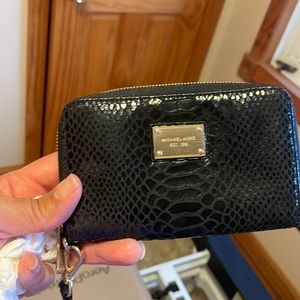 Michael korrs wall with strap